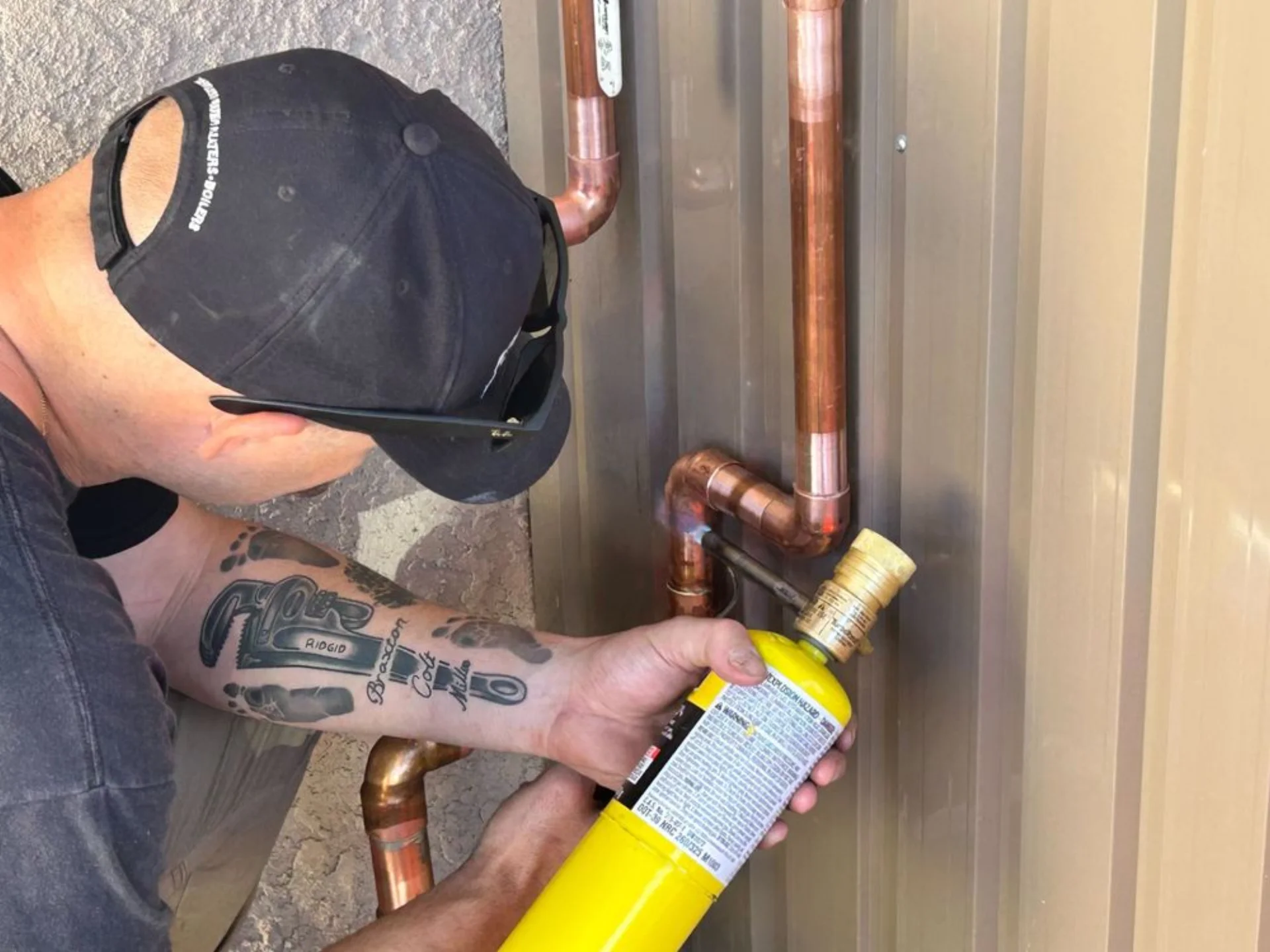 Professional plumber working on copper pipes in Lake Havasu City